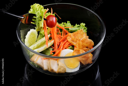 healthy salad in bowl isolate on black