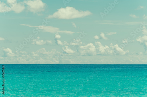 blue sky and water of ocean - vintage film filter