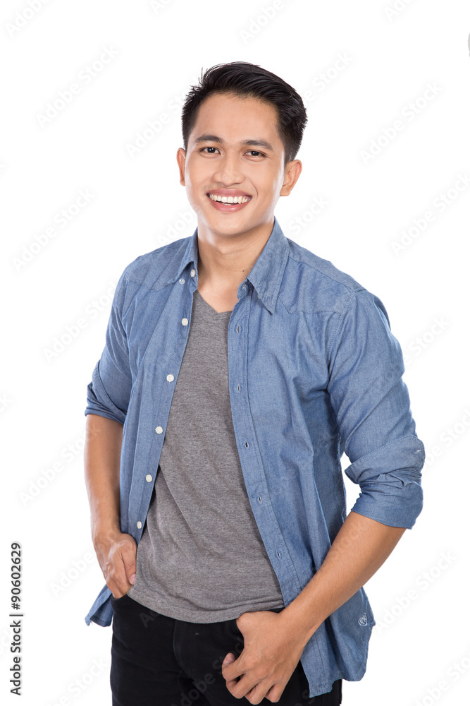 Young asian man posing hands on the waist, smile to the camera Young asian man posing hands on the waist, smile to the camera