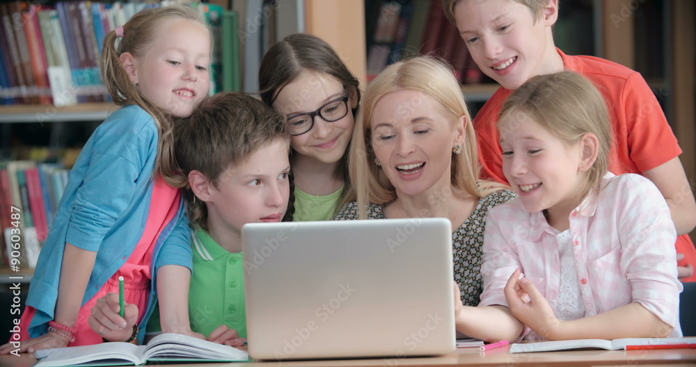 Teacher discussing a computer program with a group of pupils Teacher discussing a computer program with a group of pupils