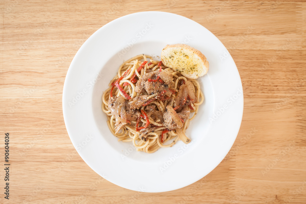 Spaghetti, spicy chicken.on wood table Spaghetti, spicy chicken.on wood table