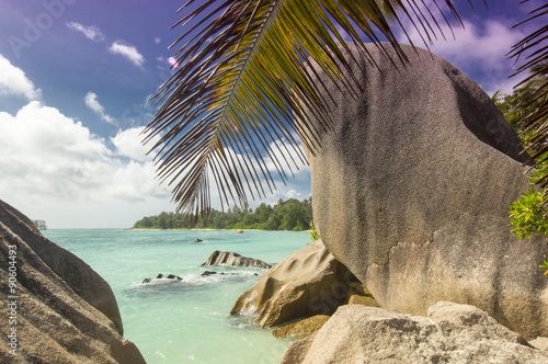 Anse Source d'Argent beach, La Digue, Seychelles.View on untouched tropical beach with Palms and boulders rocks, turquoise ocean and clear blue sky.
