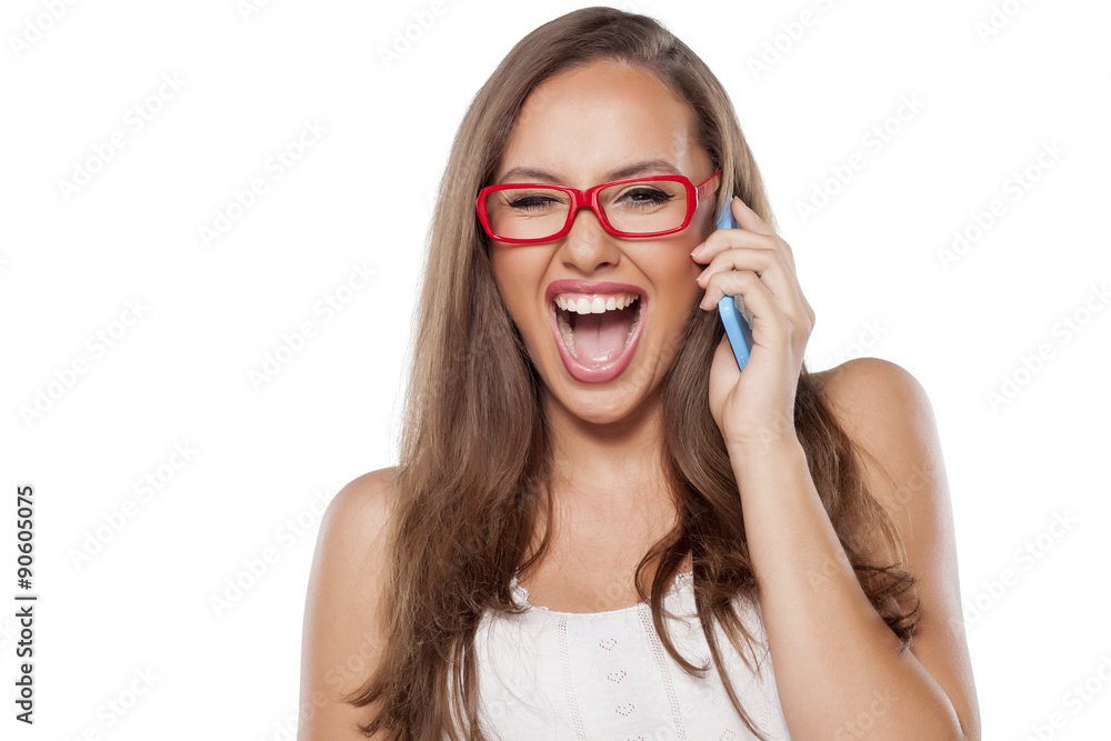 happy girl with glasses talking on the phone
