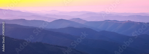 mountain peaks at sunset haze