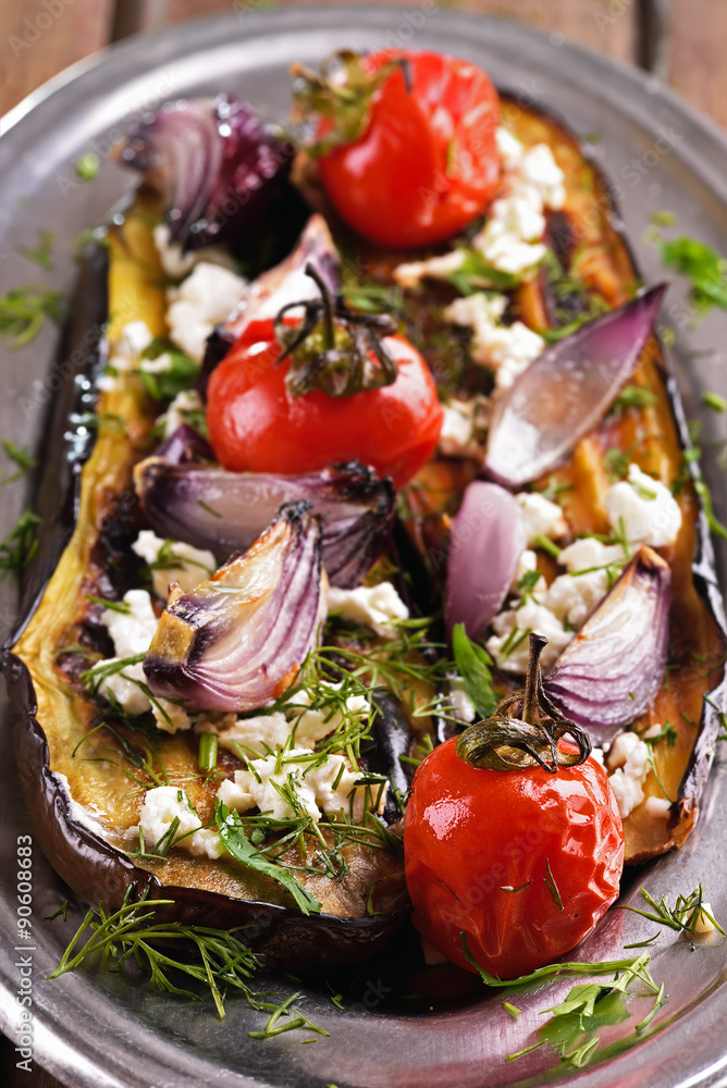 Baked eggplant with tomatoes, onion and herbs