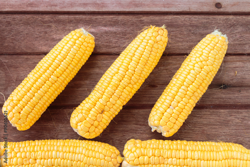 Fresh sweet corn on wooden table Fresh sweet corn on wooden table