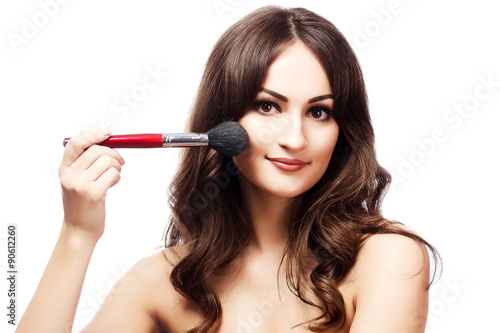Pretty woman with a makeup brush