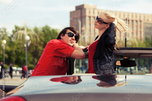 Happy young couple in convertible car