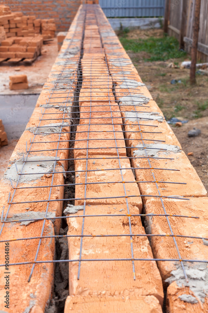 Laying red brick. New house under construction. Laying red brick. New house under construction.