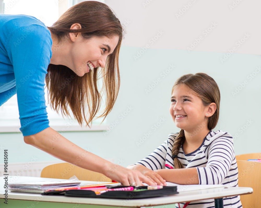 Female teacher shows the children the book, reading Female teacher shows the children the book, reading