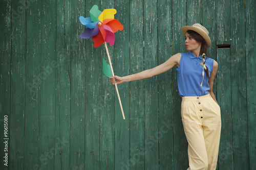 Young happy funny (vintage) dressed woman with colorful weather vane © furmananna