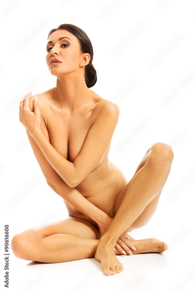 Nude woman sitting crossed legged on the floor Nude woman sitting crossed legged on the floor