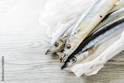 saury fish on the wooden board photo