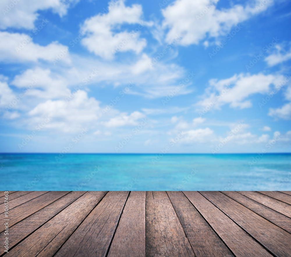 Wood table with blur seascape and blue sky background Wood table with blur seascape and blue sky background