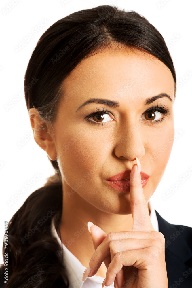 Businesswoman making silent sign Businesswoman making silent sign