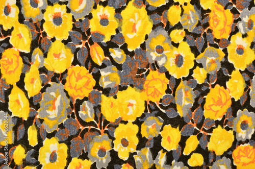 Small floral pattern on black fabric. Yellow and grey flowers print as background.