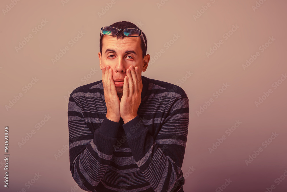 male of European appearance black hair stretches eyes with his h male of European appearance black hair stretches eyes with his h