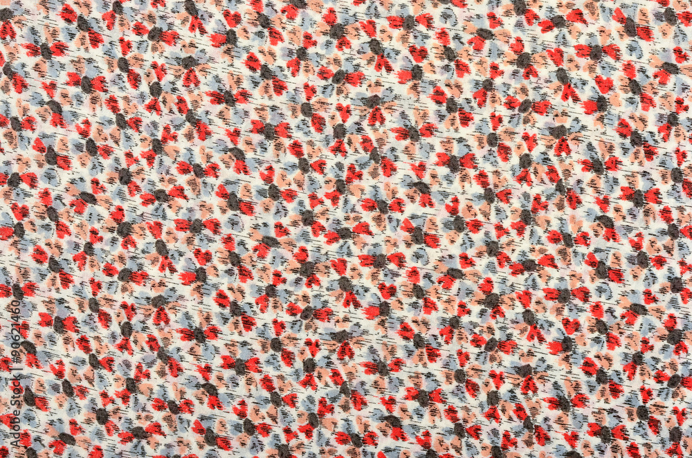 Small floral pattern on fabric. Red and gray flowers print as background.
