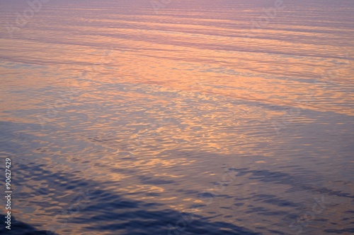 Sunset reflection in a calm sea water