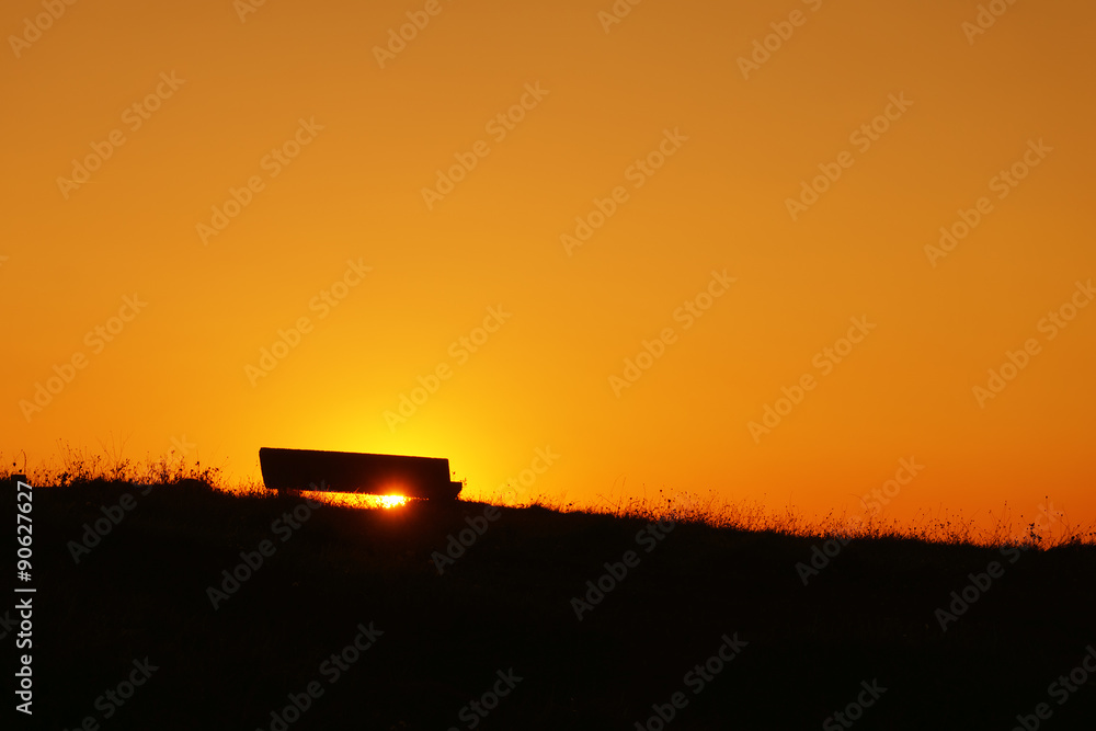 Fototapeta premium stone bench at sunset