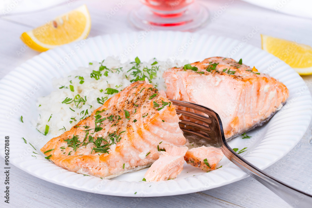 Steamed salmon with fresh herbs and lemon. Rice as a garnish Steamed salmon with fresh herbs and lemon. Rice as a garnish