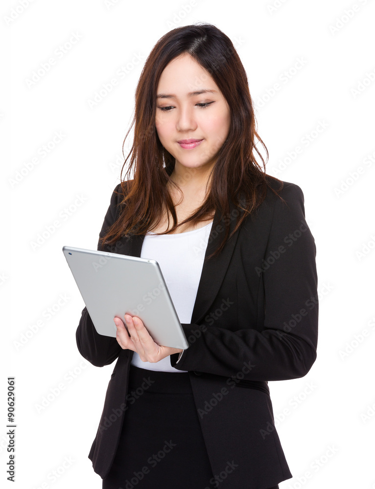 Asian young businesswoman use of the tablet pc Asian young businesswoman use of the tablet pc