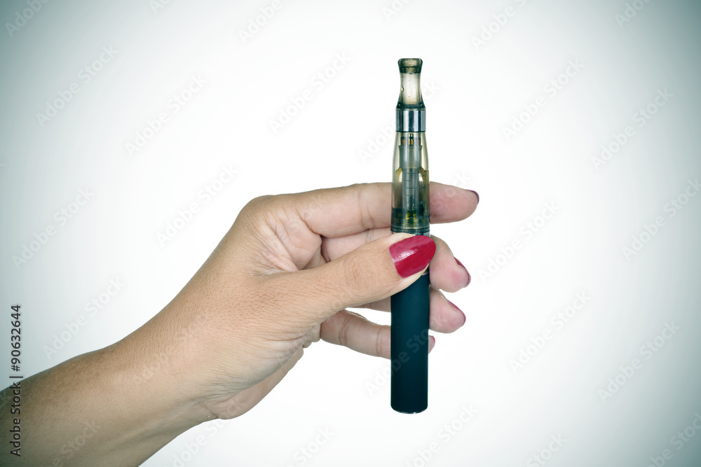 young woman showing an electronic cigarette, vignetted young woman showing an electronic cigarette, vignetted