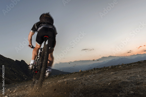 mountainbiker on the limit to keep his mountain trail