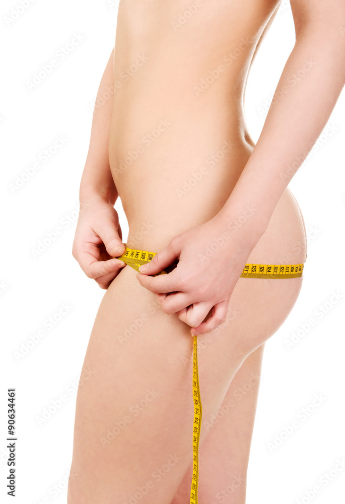 Slim woman measuring her hips. foto de Stock | Adobe Stock