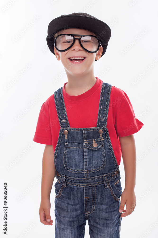 Pretty male child is making fun with strange cap Pretty male child is making fun with strange cap