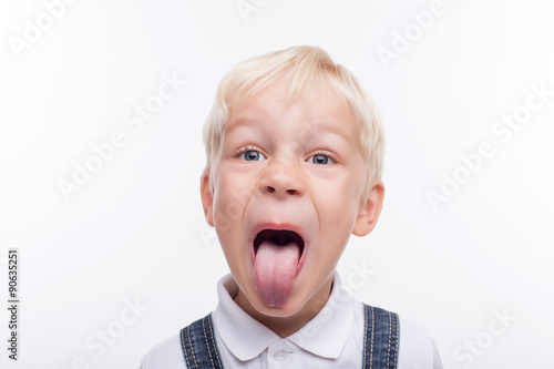 Cheerful male child is grimacing with fun