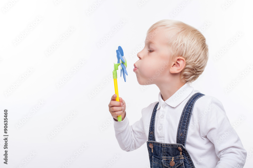 Cheerful male child is making fun with plaything Cheerful male child is making fun with plaything