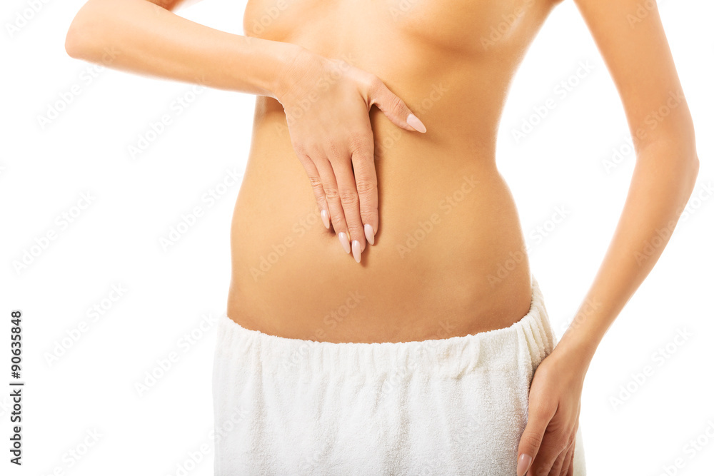 Woman massaging slim belly 