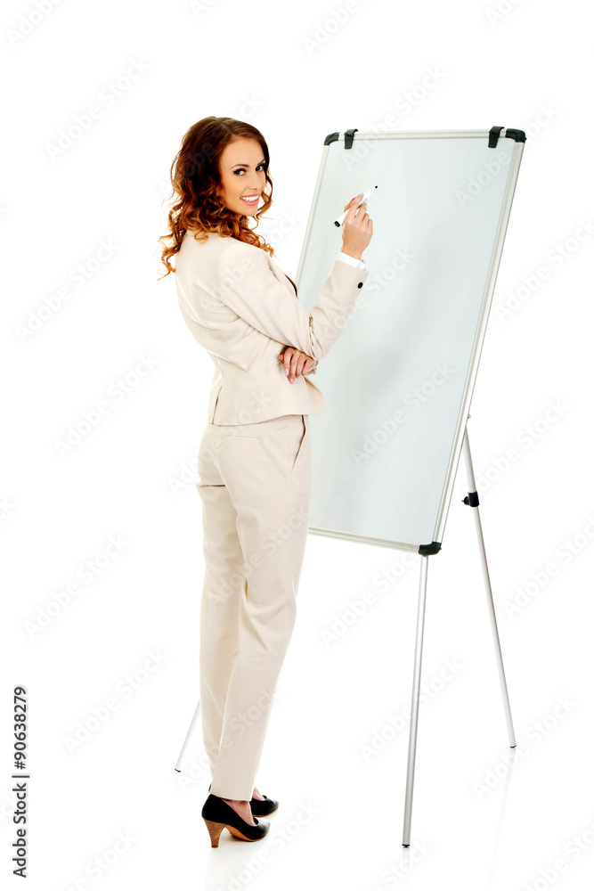 Business woman writing on flipchart. Business woman writing on flipchart.