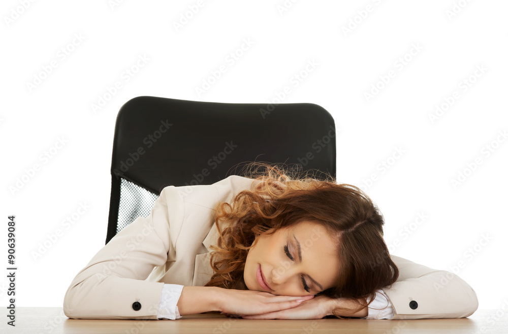Obraz premium Businesswoman having a nap at her desk.