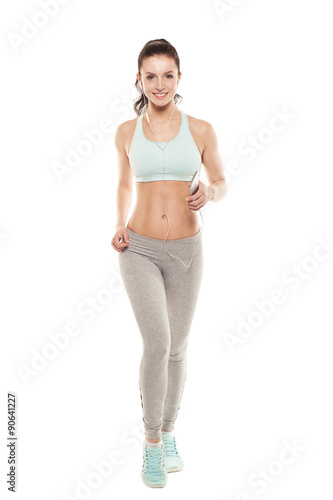 fitness girl with a smartphone on a white background, enjoys sports training, gym workout