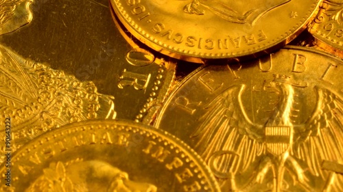 Dolly shot over various gold coins