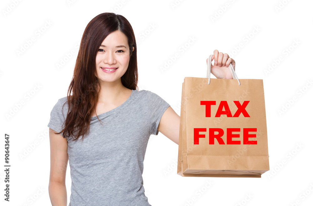 Asian Woman hold with shopping bag for showing phrase of tax fre Asian Woman hold with shopping bag for showing phrase of tax fre
