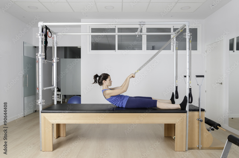 Woman doing pilates in cadillac. Woman doing pilates in cadillac.