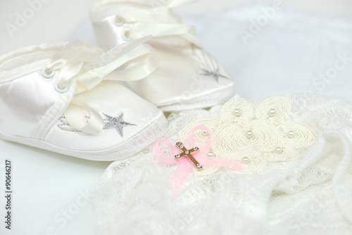 Baby shoes and cross for christening