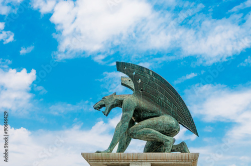 Slika na platnu Sculpture of gargoyle on blue sky background