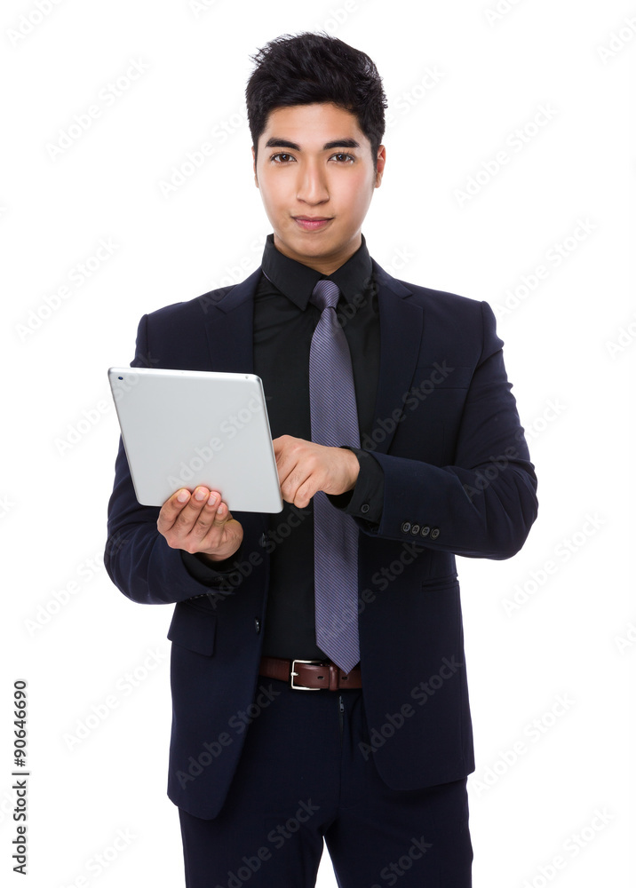 Asian businessman use of the tablet pc Asian businessman use of the tablet pc