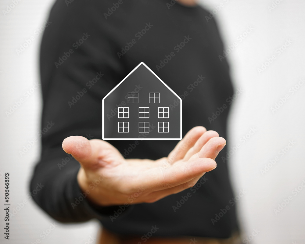 man holding virtual house. Property and real estate concept man holding virtual house. Property and real estate concept