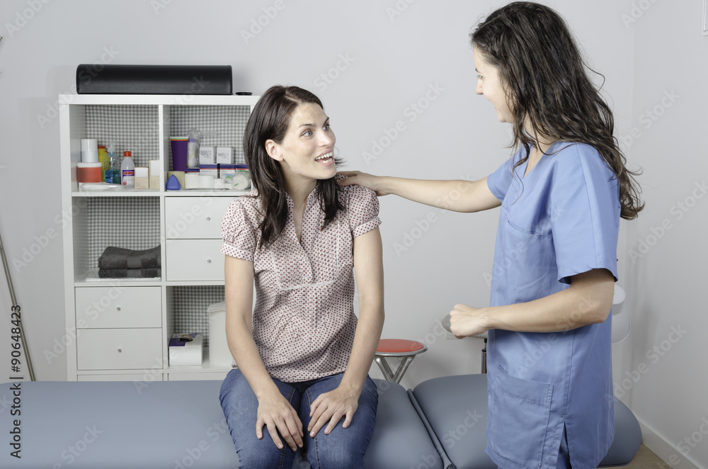 Young doctor/ physiotherapist with a woman patient. Young doctor/ physiotherapist with a woman patient.