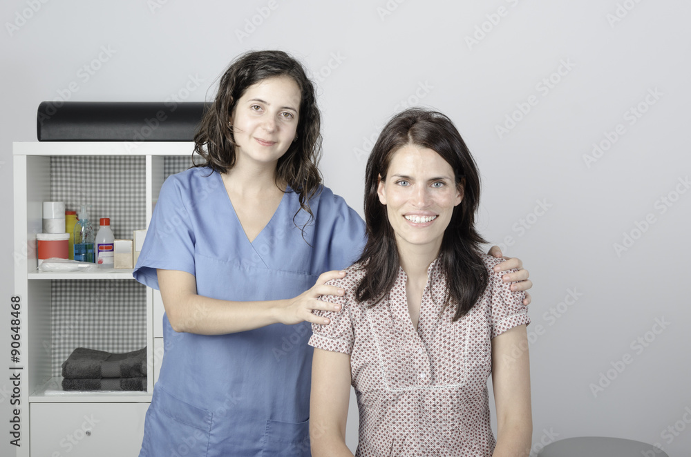 Young doctor/ physiotherapist with a woman patient. Young doctor/ physiotherapist with a woman patient.