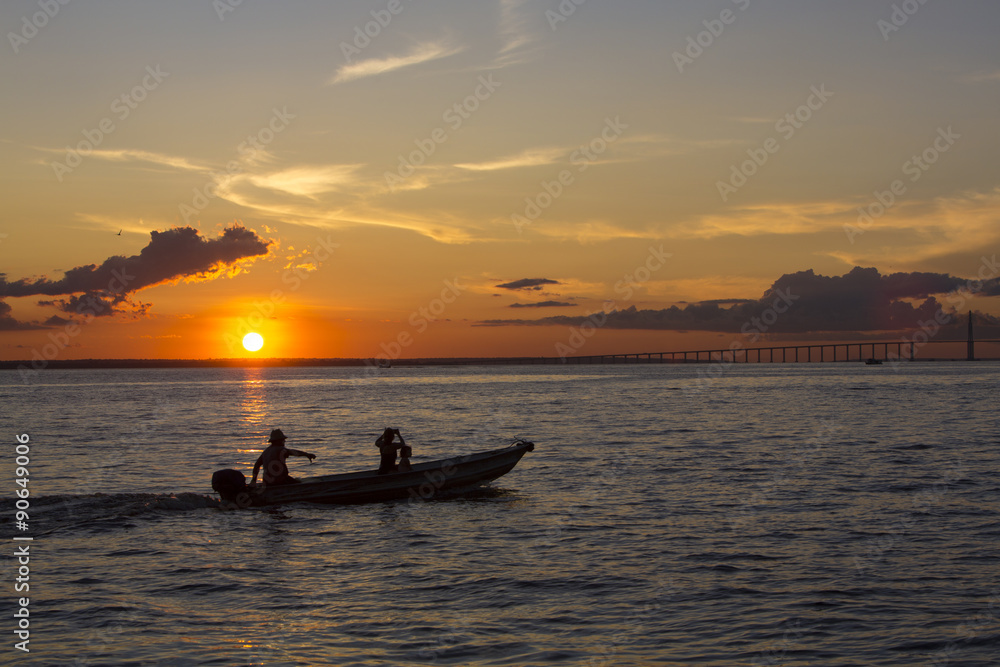 Sunset and silhouettes on boat cruising the Amazon River, Brazil