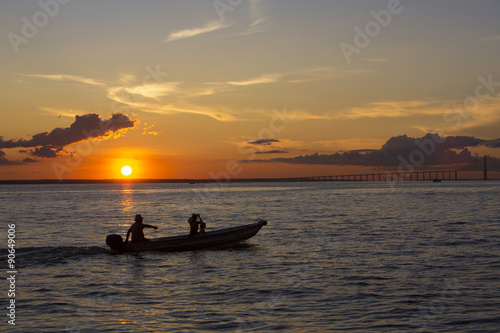 Sunset and silhouettes on boat cruising the Amazon River, Brazil