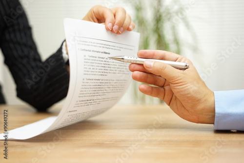 businesswoman holding legal document and  wants an explaination photo