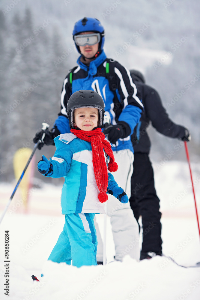Father and son, skiing in the winter, boy learning to ski, going