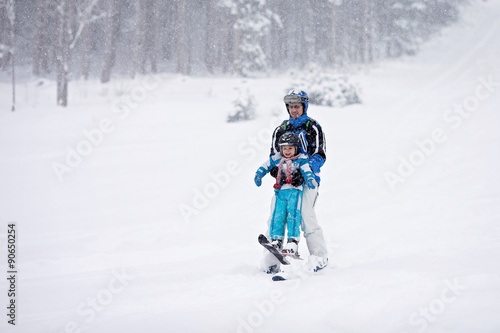 Father and son, skiing in the winter, boy learning to ski